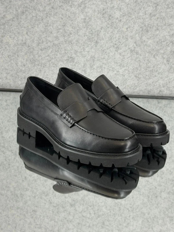Hermès Klement Loafer in black buffalo leather with a chunky rubber sole.