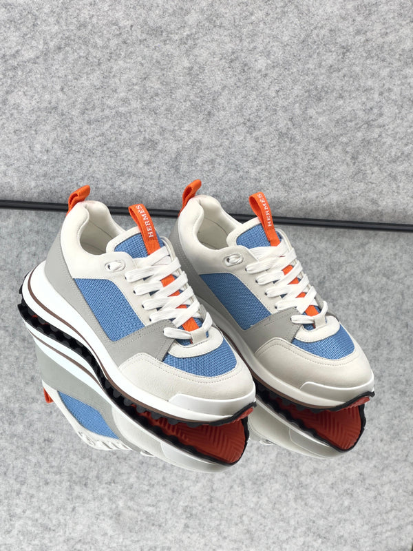 Hermès Leader Sneaker in technical twill, calfskin, and suede goatskin.