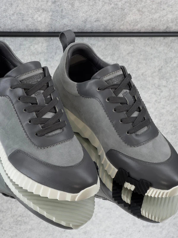 Hermès Bouncing Sneakers in the Gris Orage colorway, crafted from suede goatskin and calfskin.