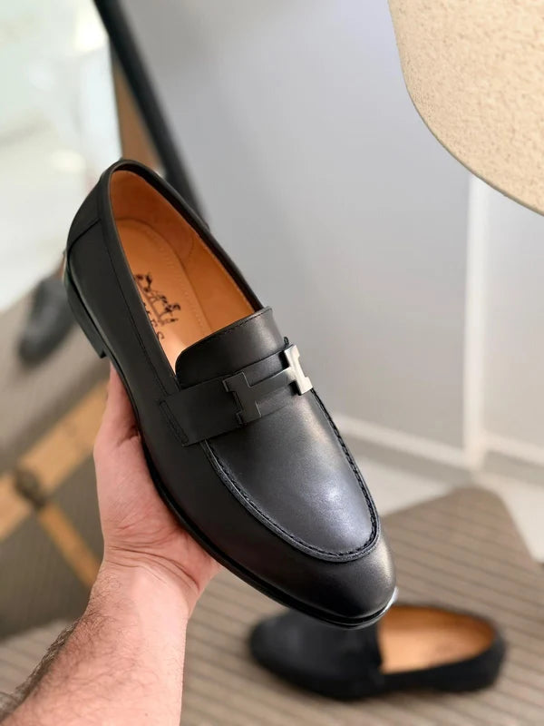 Hermès Paris loafers, a classic slip-on shoe crafted in black grained calfskin
